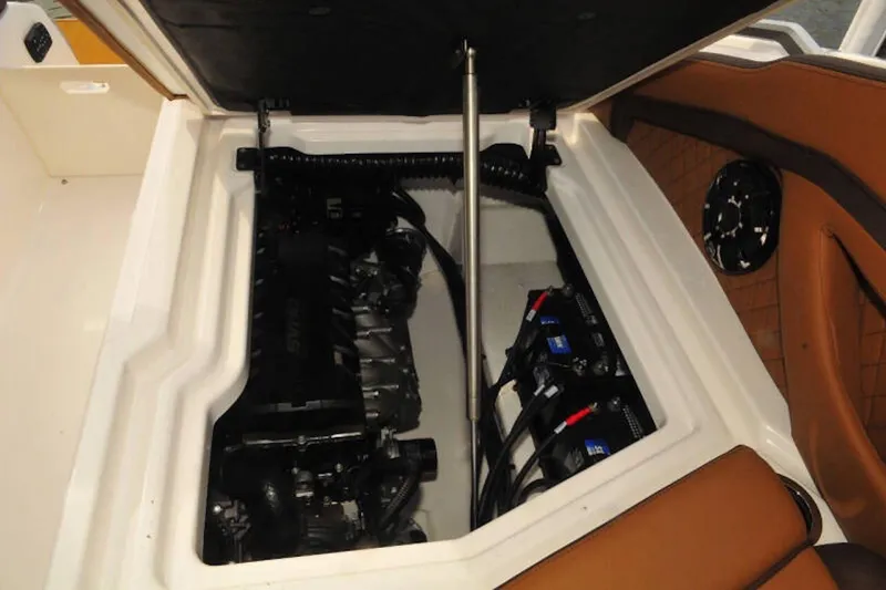 Slide: The Image of Engine compartment of 2024 Yamaha Boats 275SDX, showcasing engine and battery setup. - 21