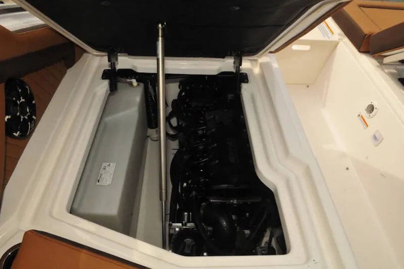 Slide: The Image of Engine compartment of 2024 Yamaha Boats 275SDX, showcasing internal components and storage area. - 22
