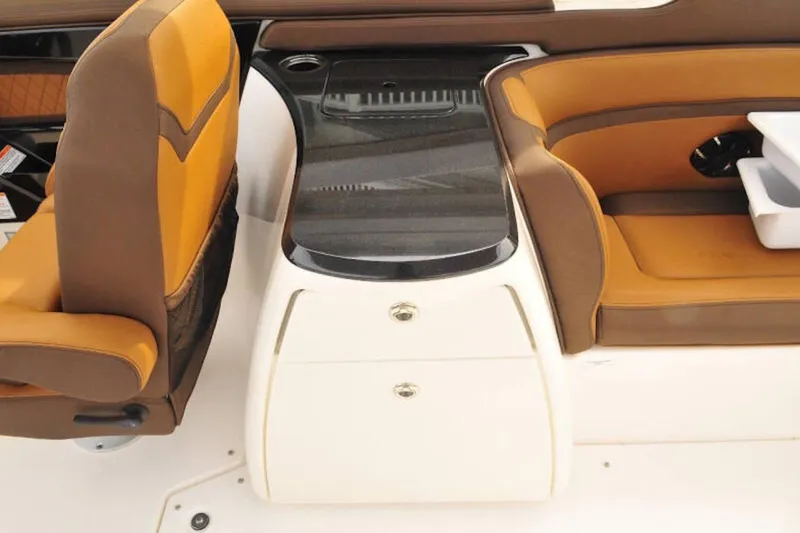 Slide: The Image of 2024 Yamaha Boats 275SDX interior with brown seating and sleek console design. - 23