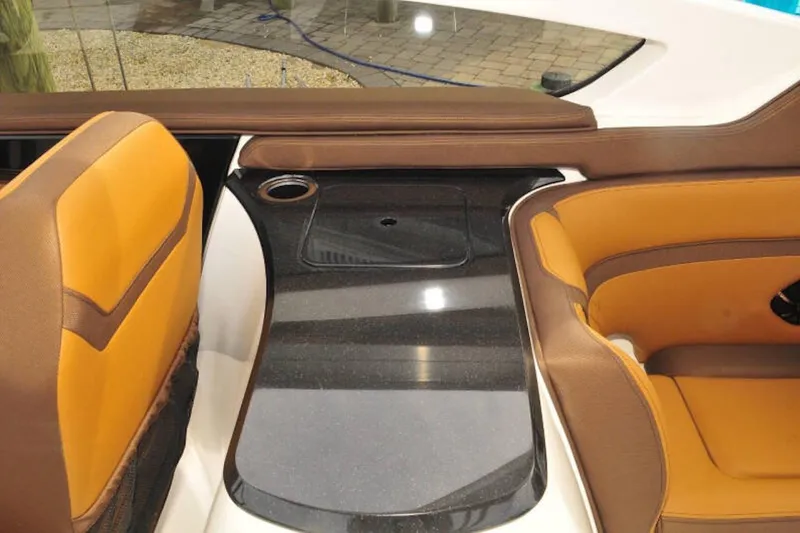 Slide: The Image of 2024 Yamaha Boats 275SDX interior with brown and orange seating, sleek design. - 24