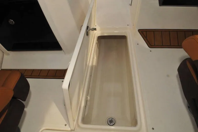 Slide: The Image of 2024 Yamaha Boats 275SDX storage compartment with open hatch, showcasing interior space. - 27