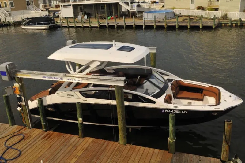 Slide: The Image of 2024 Yamaha Boats 275SDX docked at a marina, showcasing sleek design and modern features. - 3