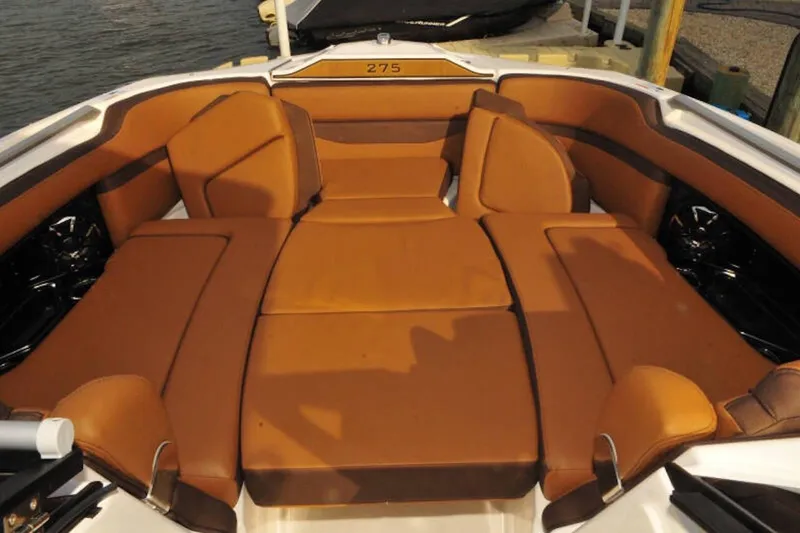 Slide: The Image of 2024 Yamaha Boats 275SDX interior with luxurious brown seating and spacious layout. - 30