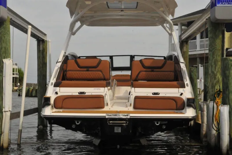 Slide: The Image of 2024 Yamaha Boats 275SDX in dock, showcasing luxurious seating and sleek design. - 5