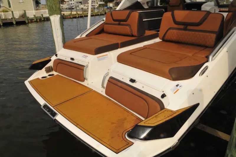 Slide: The Image of 2024 Yamaha Boats 275SDX with luxurious brown seating and swim platform. - 6