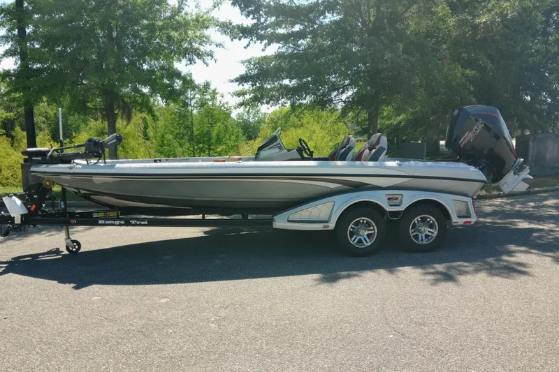 The Image of 2023 Ranger Z520R boat on trailer, parked outdoors with trees in background. - 1