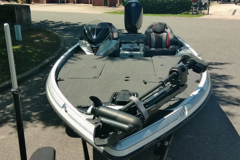 Slide: The Image of 2023 Ranger Z520R fishing boat with trolling motor and dual seats on a sunny day. - 2