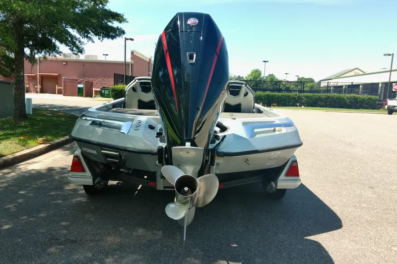 Slide: The Image of 2023 Ranger Z520R boat with powerful outboard motor in a parking lot. - 4