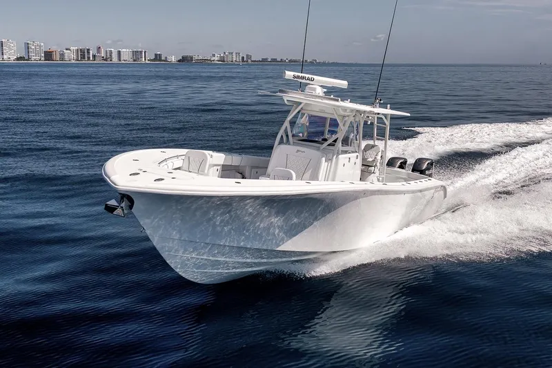 Slide: The Image of 2012 Yellowfin 39 Offshore boat cruising on open water near city skyline. - 10