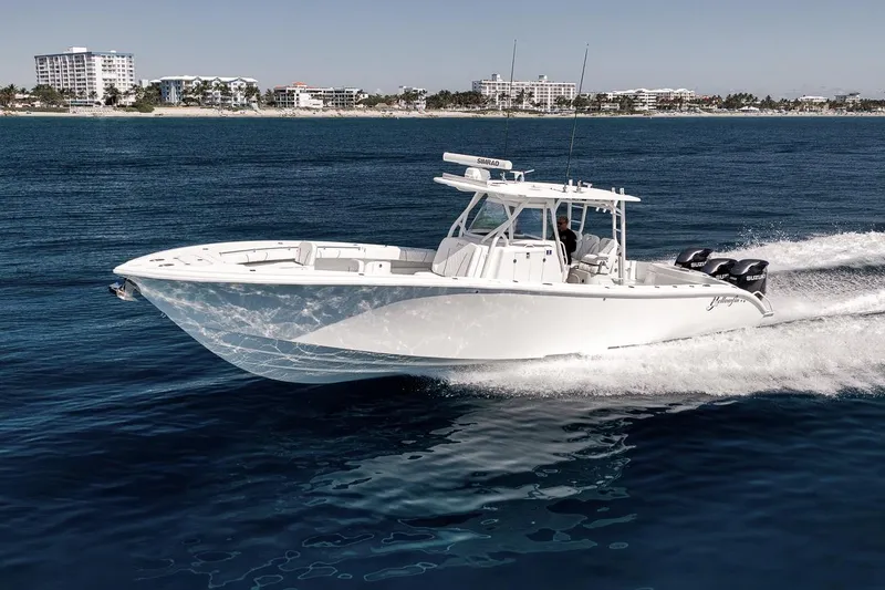 Slide: The Image of 2012 Yellowfin 39 Offshore boat cruising on open water near a coastal city. - 13