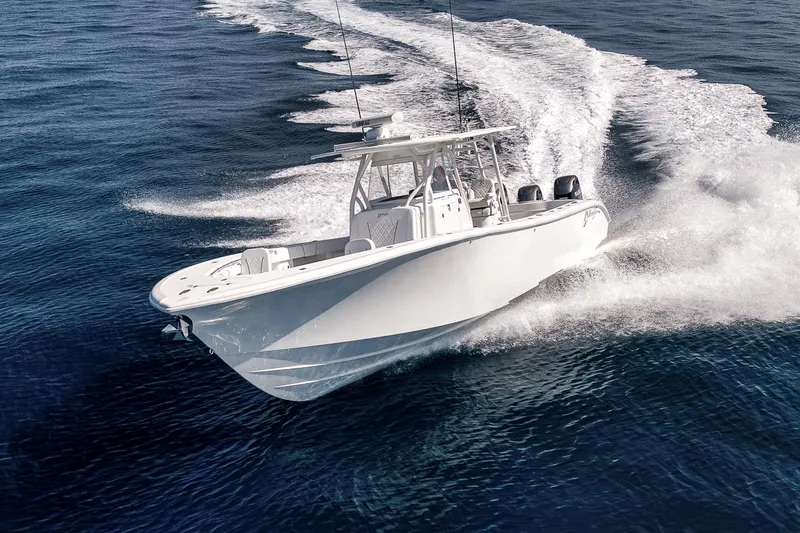 Slide: The Image of 2012 Yellowfin 39 Offshore boat cruising on open water, creating a dynamic wake. - 15