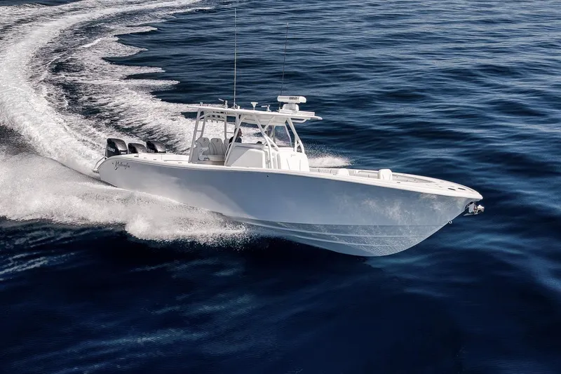 Slide: The Image of 2012 Yellowfin 39 Offshore boat cruising on open water, showcasing sleek design and powerful engines. - 16