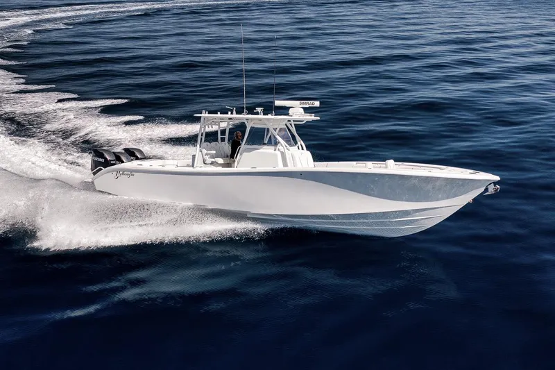 Slide: The Image of 2012 Yellowfin 39 Offshore boat cruising on open water, showcasing sleek design and powerful engines. - 18