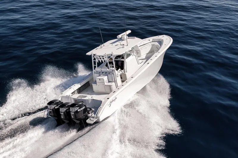 Slide: The Image of 2012 Yellowfin 39 Offshore boat cruising on open water with powerful engines. - 19