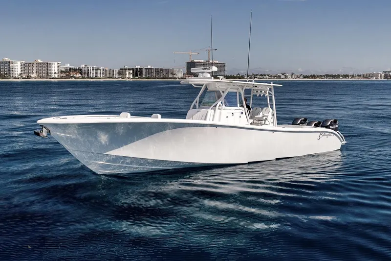 Slide: The Image of 2012 Yellowfin 39 Offshore boat on calm blue water near city skyline. - 2