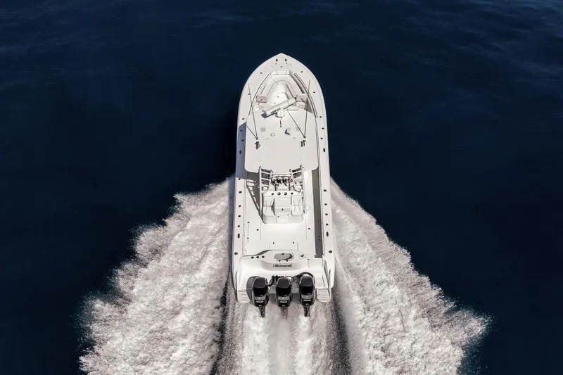 Slide: The Image of 2012 Yellowfin 39 Offshore boat cruising on open water, aerial view. - 22