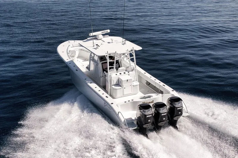 Slide: The Image of 2012 Yellowfin 39 Offshore boat cruising on open water with triple engines. - 23