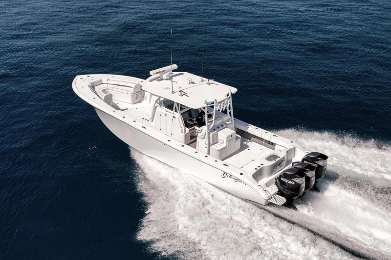 Slide: The Image of 2012 Yellowfin 39 Offshore boat cruising on open water with powerful engines. - 24