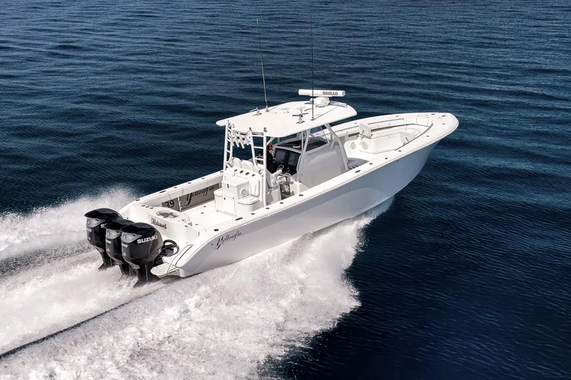Slide: The Image of 2012 Yellowfin 39 Offshore boat cruising on open water, powered by Suzuki engines. - 25