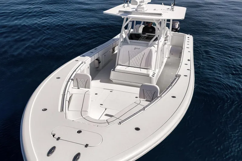 Slide: The Image of 2012 Yellowfin 39 Offshore boat on calm blue water, showcasing sleek design and spacious deck. - 27