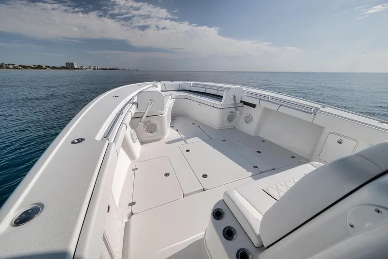Slide: The Image of 2012 Yellowfin 39 Offshore boat with spacious deck, cruising on calm ocean waters. - 30