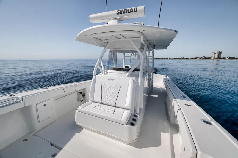 Slide: The Image of 2012 Yellowfin 39 Offshore boat on calm ocean waters, featuring sleek design and spacious deck. - 33