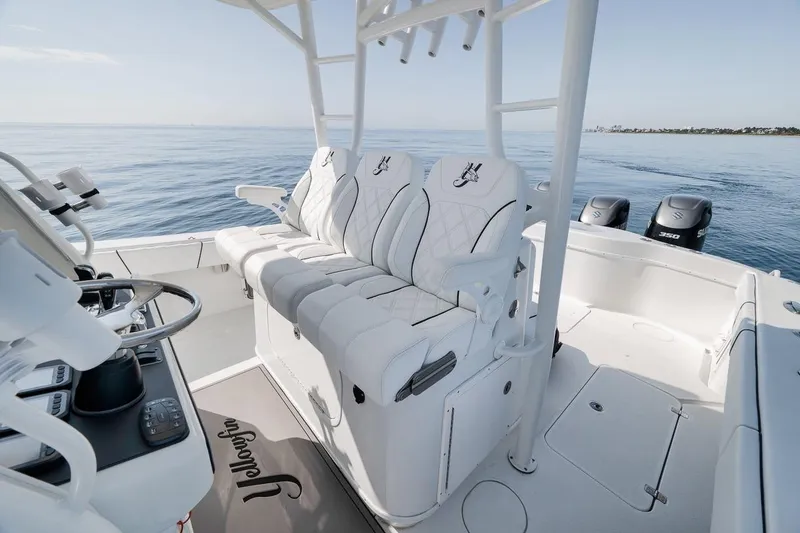 Slide: The Image of 2012 Yellowfin 39 Offshore boat interior with white seating and triple outboard engines. - 34