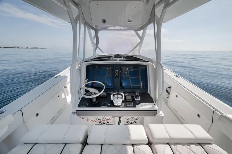 Slide: The Image of 2012 Yellowfin 39 Offshore boat cockpit with steering wheel and navigation screens. - 36