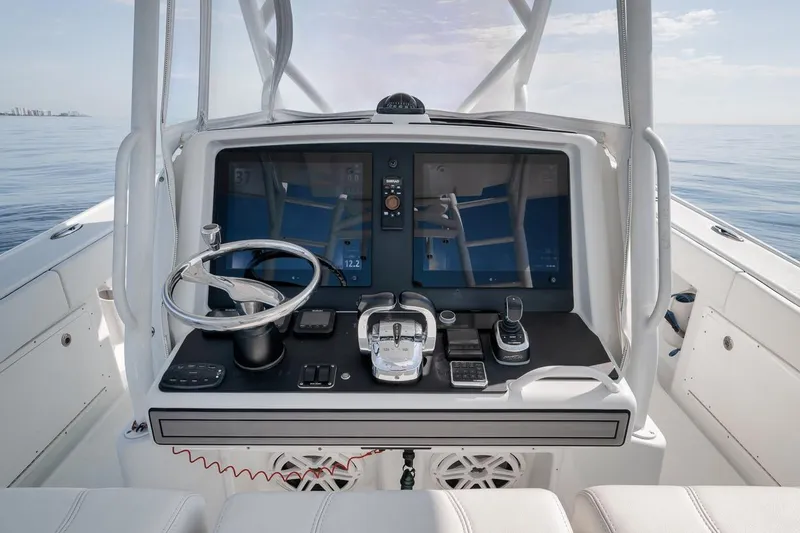 Slide: The Image of 2012 Yellowfin 39 Offshore boat dashboard with modern navigation equipment and steering wheel. - 37