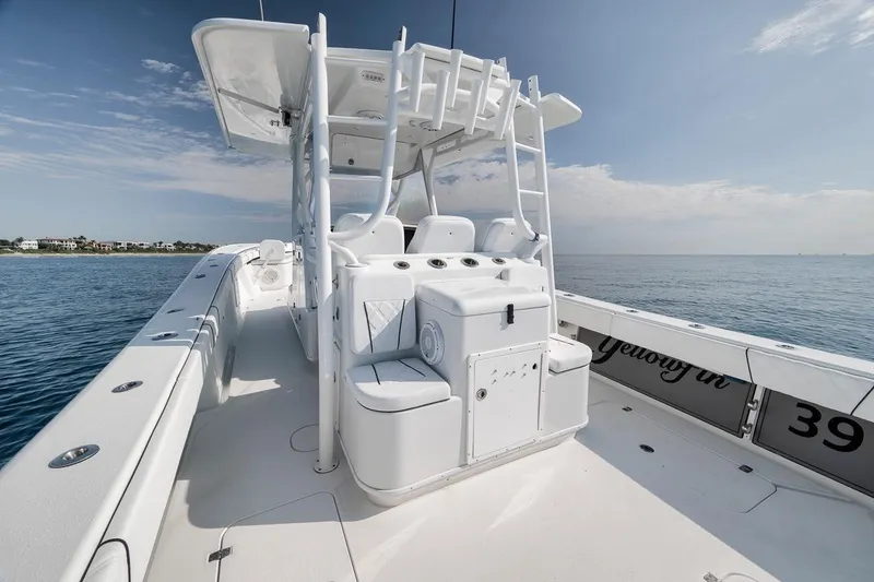 Slide: The Image of 2012 Yellowfin 39 Offshore boat interior, showcasing spacious deck and seating on calm waters. - 41