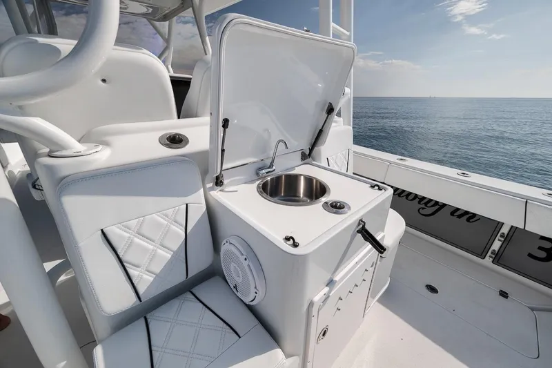 Slide: The Image of 2012 Yellowfin 39 Offshore boat interior with sink and seating, ocean view. - 42