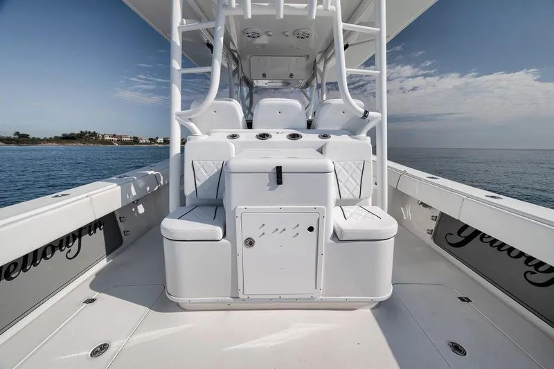 Slide: The Image of 2012 Yellowfin 39 Offshore boat interior with white seating and ocean view. - 43