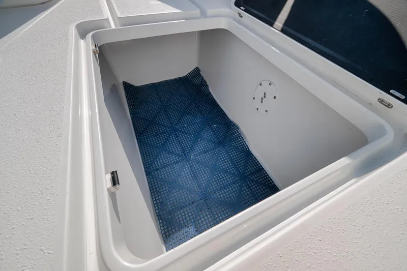 Slide: The Image of Storage compartment on a 2012 Yellowfin 39 Offshore boat, featuring a blue non-slip mat. - 44