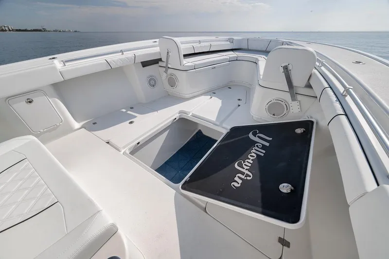 Slide: The Image of 2012 Yellowfin 39 Offshore boat interior with spacious seating and storage, overlooking calm ocean waters. - 45