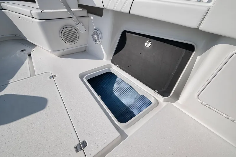 Slide: The Image of 2012 Yellowfin 39 Offshore boat interior with open storage compartment and speakers. - 46