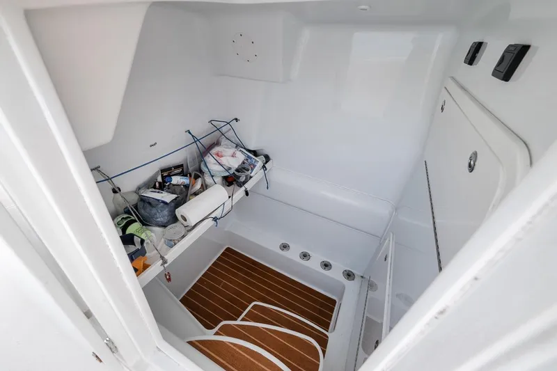 Slide: The Image of Interior storage area of a 2012 Yellowfin 39 Offshore boat with various items. - 49