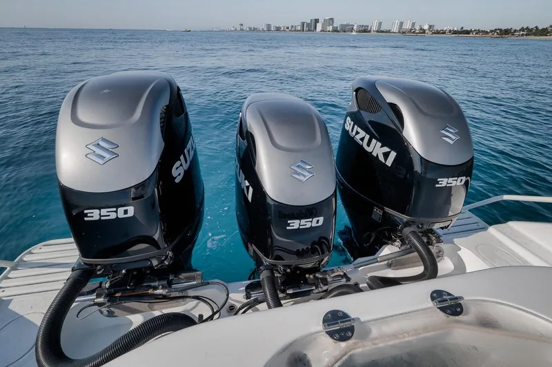 Slide: The Image of Triple Suzuki 350 outboard engines on a 2012 Yellowfin 39 Offshore boat, ocean backdrop. - 57