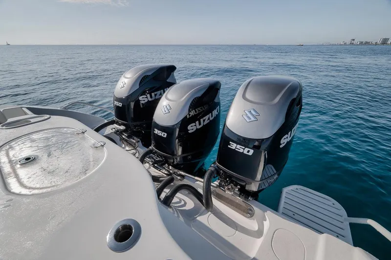 Slide: The Image of 2012 Yellowfin 39 Offshore boat with triple Suzuki 350 engines on open water. - 58