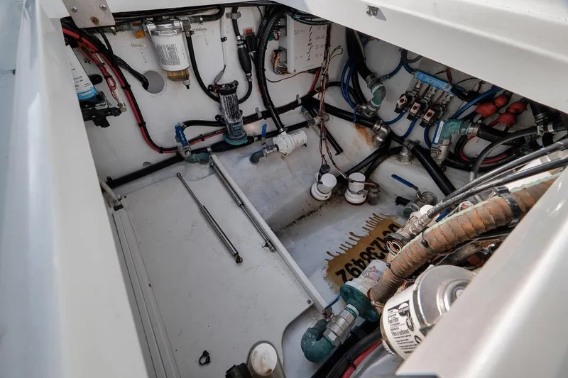Slide: The Image of Engine compartment of a 2012 Yellowfin 39 Offshore boat, showcasing wiring and components. - 59