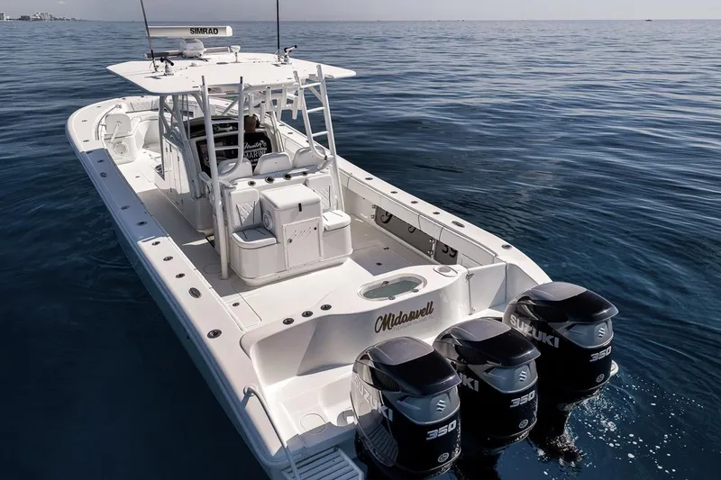 Slide: The Image of 2012 Yellowfin 39 Offshore boat with triple Suzuki 350 engines on calm ocean waters. - 6