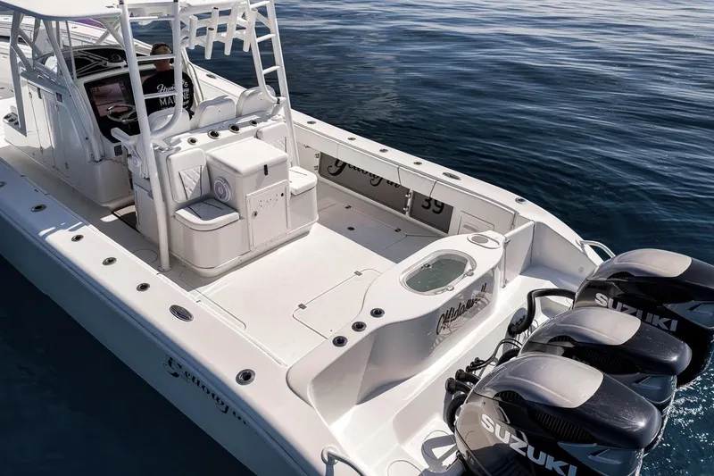 Slide: The Image of 2012 Yellowfin 39 Offshore boat with triple Suzuki engines on calm water. - 7