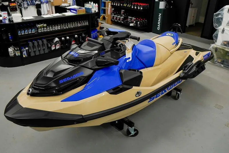 The Image of 2026 Sea-Doo Wake Pro 230 jet ski in showroom, blue and beige design. - 1
