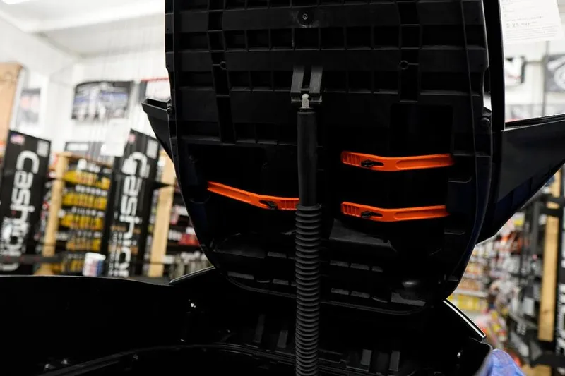 Slide: The Image of 2026 Sea-Doo Wake Pro 230 storage compartment with orange straps in a showroom. - 21
