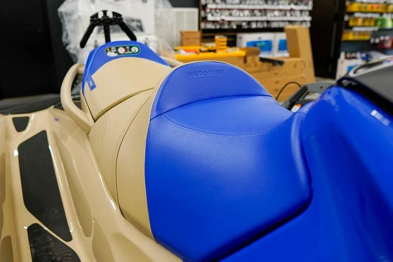 Slide: The Image of 2026 Sea-Doo Wake Pro 230 with blue and beige seating in a showroom. - 26