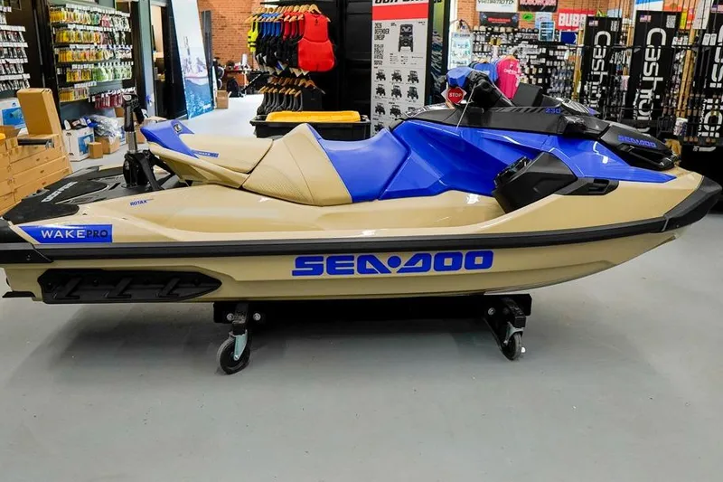 Slide: The Image of 2026 Sea-Doo Wake Pro 230 jet ski displayed in a showroom. - 4