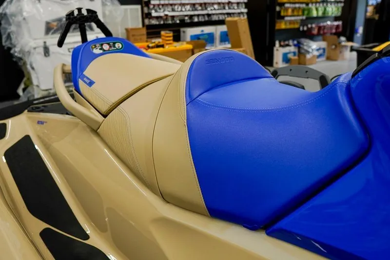 Slide: The Image of 2026 Sea-Doo Wake Pro 230 jet ski with blue and beige seating in a showroom. - 9
