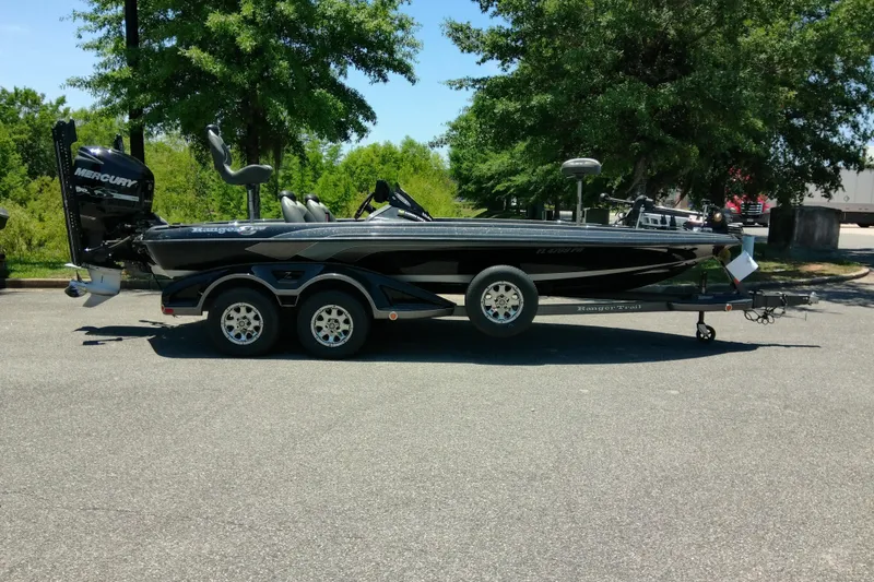 Slide: The Image of 2012 Ranger Z520 boat with Mercury engine on trailer, parked outdoors. - 3
