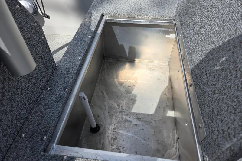 Slide: The Image of Open storage compartment in 2023 Starcraft Patriot 16 SC boat interior. - 7