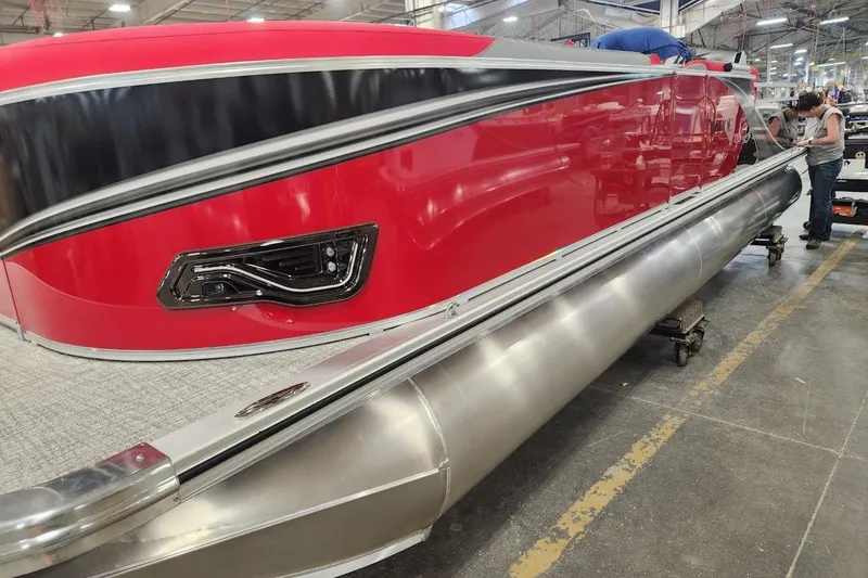 The Image of 2026 Tahoe Pontoon LTZ 2585 VRB in a factory setting, showcasing sleek red design. - 1
