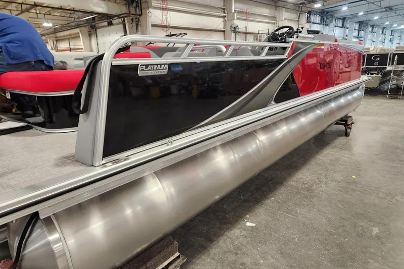 Slide: The Image of 2026 Tahoe Pontoon LTZ 2585 VRB in a showroom, showcasing sleek design and red accents. - 8